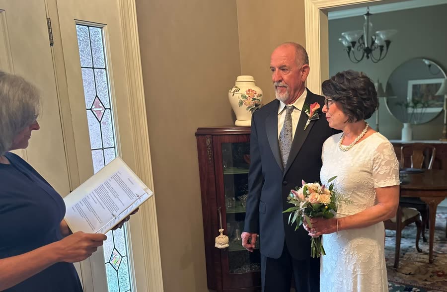 Beth officiating an intimate wedding ceremony at home